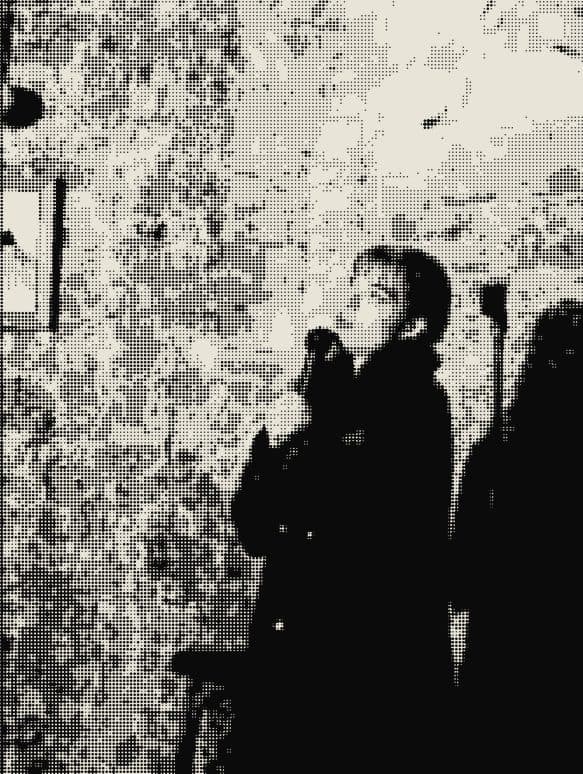 A performer against a brick wall
